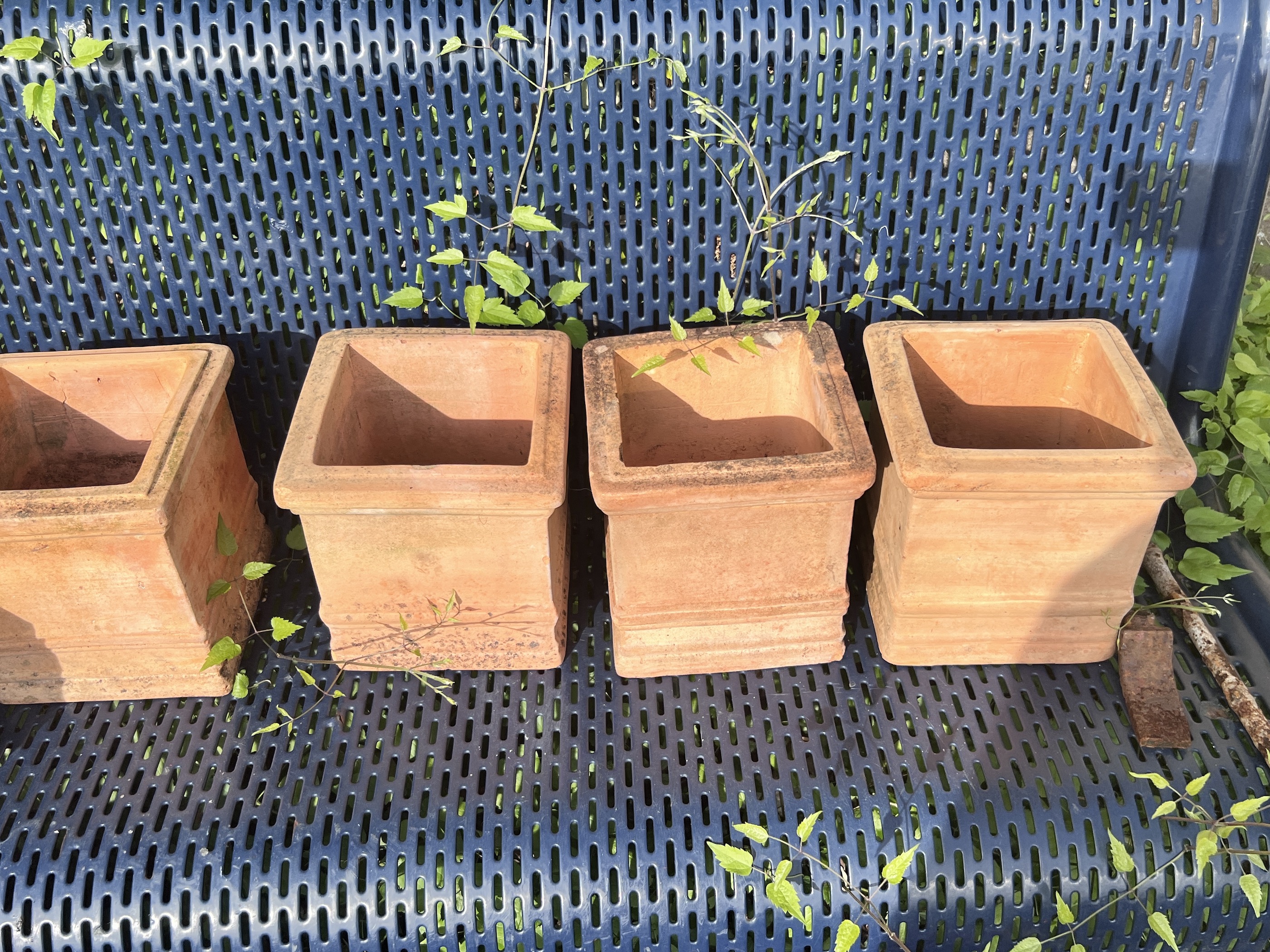 A large circular galvanised tub, diameter 72cm, together with a quantity of assorted terracotta garden pots